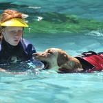 Katie plays with a dog during Splash Days.