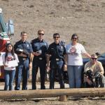 San Luis Obispo County Fire & SLO Sheriff's Departments pose with DogE911 after receiving their donations. 