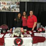 Genete & youth pose during a disaster fair event.